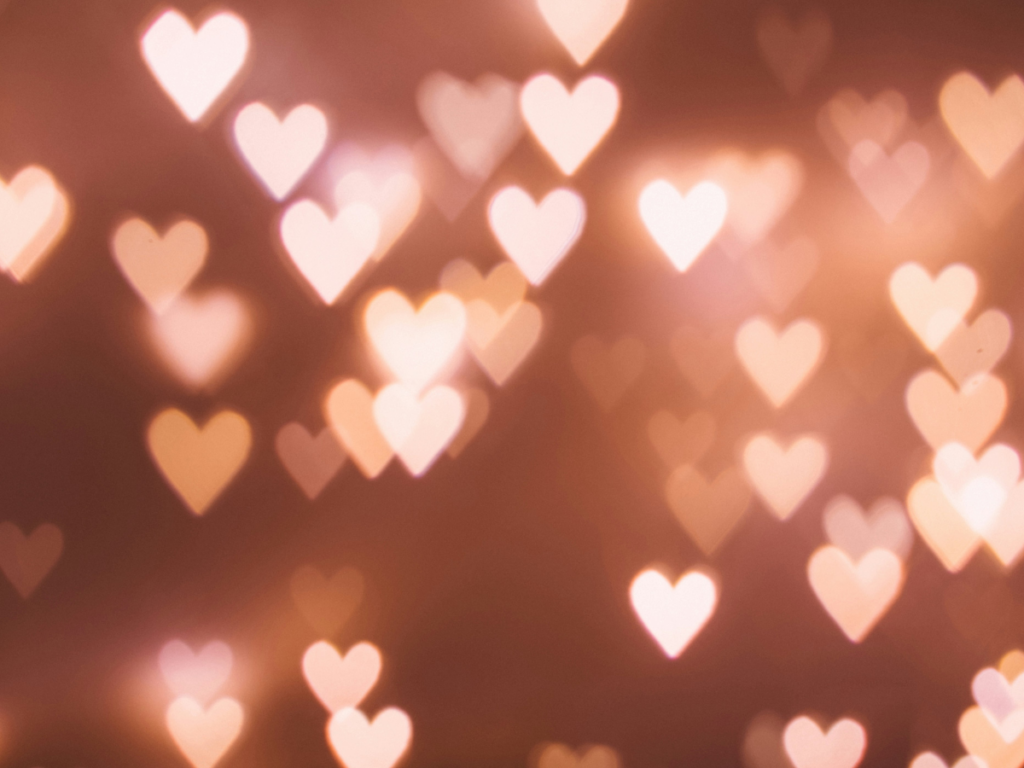Heart bokeh pattern against a pink/peach background.