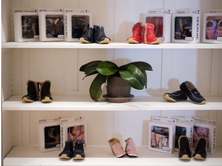 Footwear display. Children's' shoes are in a display cabinet. Skeanie's are visible