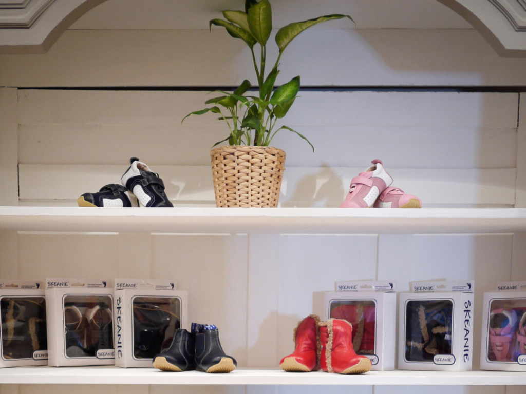 Footwear display. Children's' shoes are in a display cabinet. Skeanie's are visible