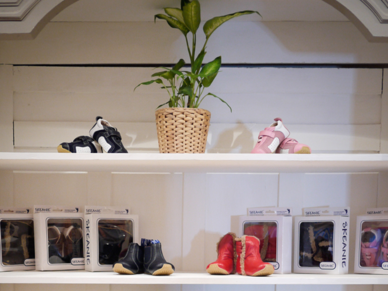 Footwear display. Children's' shoes are in a display cabinet. Skeanie's are visible