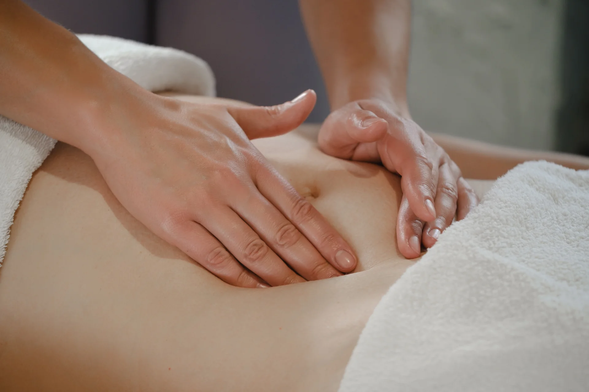 woman receiving professional belly massage in well 2026 01 08 22 24 07 utc