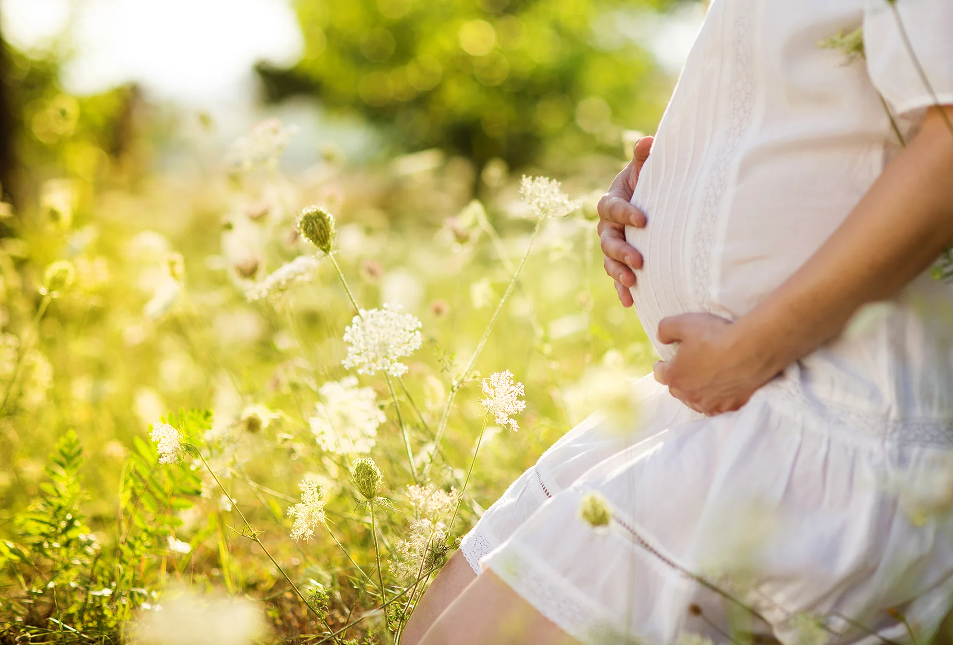 expecting woman embracing baby bump