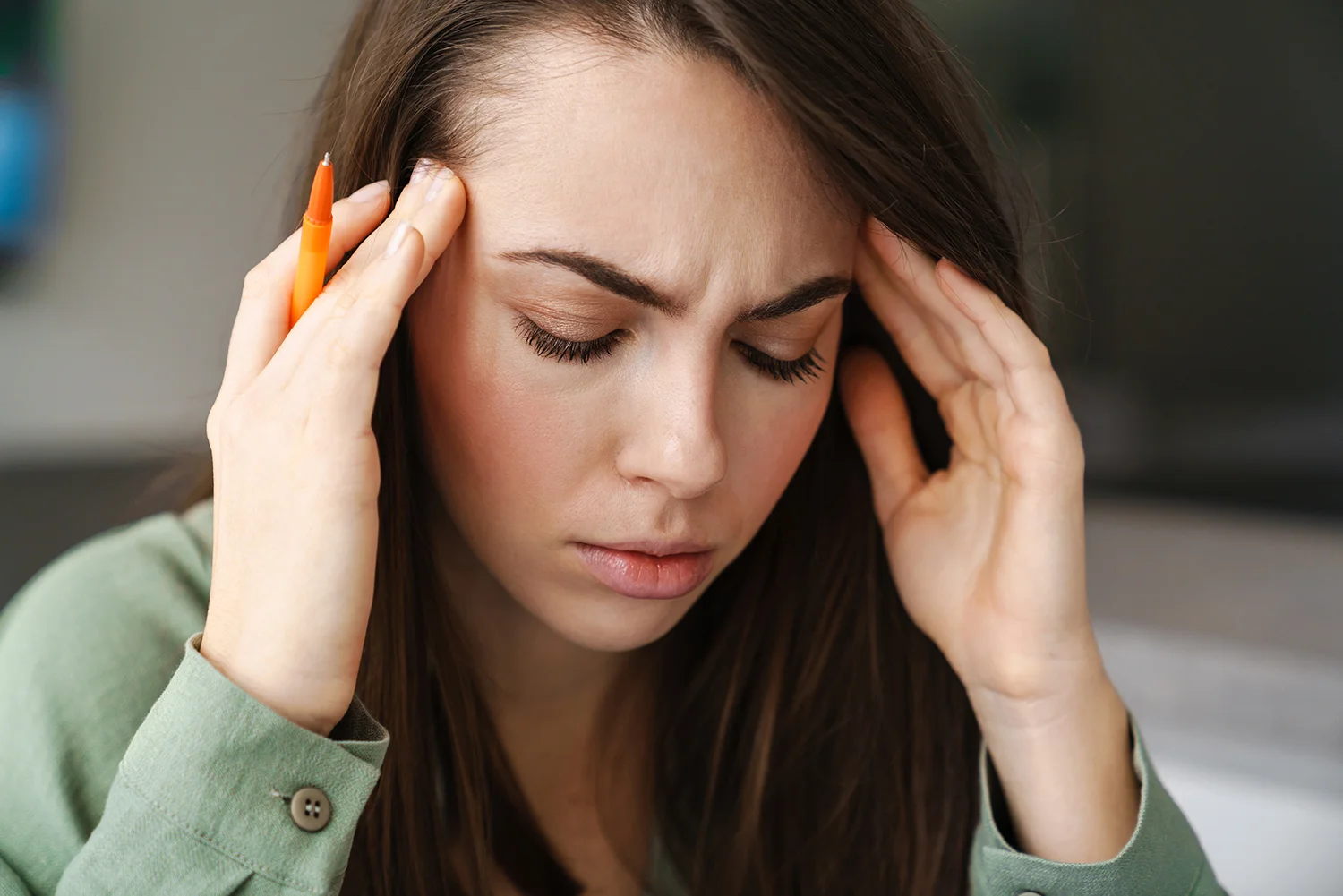 woman feeling anxious with hands on head