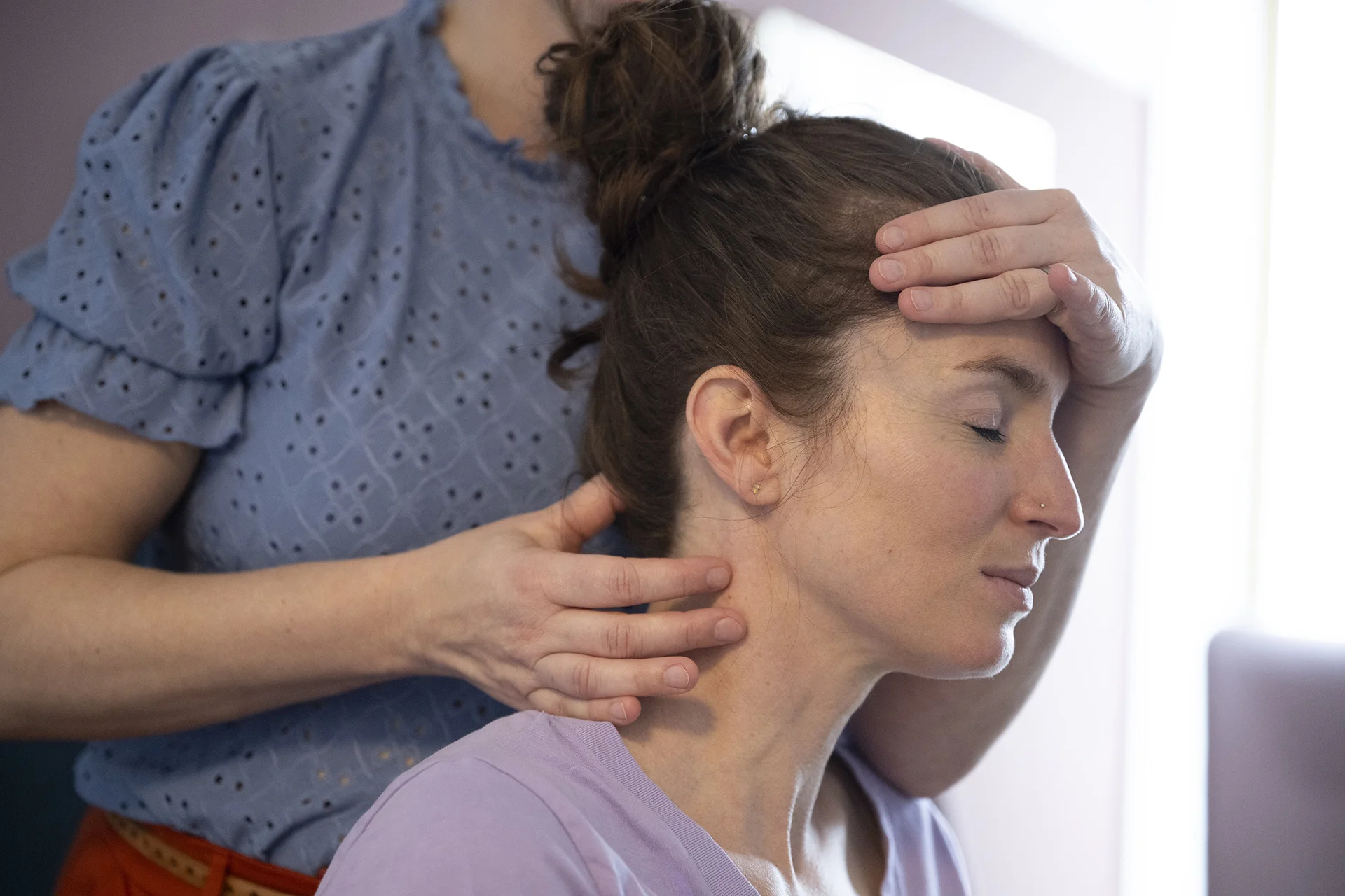 woman receiving face massage from another woman